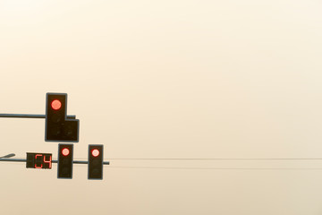 Red traffic signs under the golden evening sky.