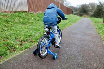 boy riding a blue bike