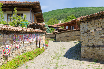 Stone street and souvenir shop in the 19th century village of Zheravna, Bulgaria