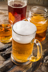 Homemade Kombucha beer, with Kombucha jars on wooden background