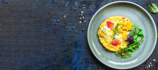 omelette scrambled vegetables and salad, healthy snack (corn, tomato, onion and other ingredients) menu concept background. top view. copy space