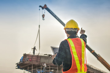 Foreman holding tablet use technology inspection control construction architecture site