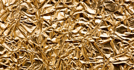 Gold wrinkled shiny textured metallic paper abstract background, web banner