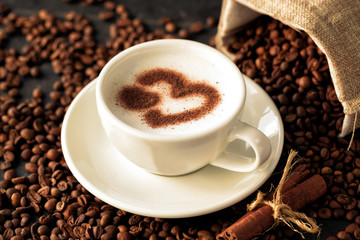 Heart shaped latte art on a coffee bean background