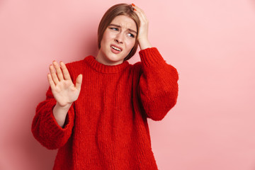 Photo of unhappy blonde woman with headache making stop gesture