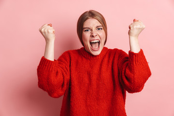 Photo of furious blonde woman screaming with fists clinched