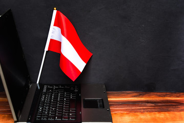  flag of Austria ,  computer, laptop  on table and dark background