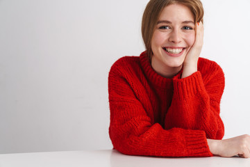 Photo of happy beautiful woman smiling while sitting at table