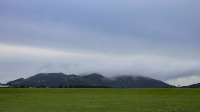 Shot of clouds rolling over hills near Kiripaka Road, in Tikipunga, New Zealand.
