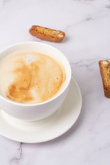 cup of coffee and cookies with nuts on a white background close-up