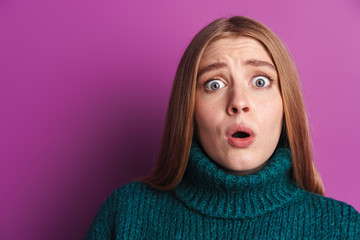 Photo of scared caucasian woman in green sweater expressing surprise