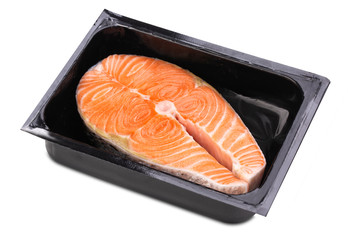 One fresh raw Norwegian salmon steak in a black plastic box