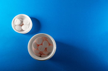 White medical pills and tablets with bottle