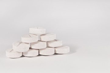 White medical pills and tablets with bottle