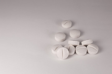 White medical pills and tablets with bottle