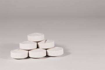 White medical pills and tablets with bottle