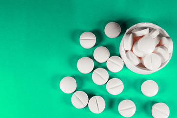 White medical pills and tablets with bottle