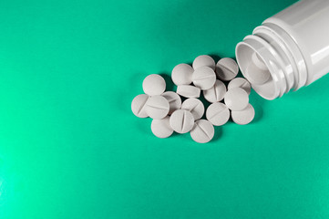 White medical pills and tablets with bottle
