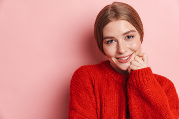 Photo of pleased beautiful woman smiling and looking at camera