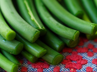 Sliced garlic sticks are very tender and delicious. They are also known as garlic spears , stems , or tops .