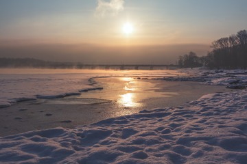 Winter landscape near the river and bridge