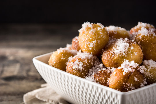 Carnival fritters or bu&ntilde;uelos de viento for holy week on wooden table