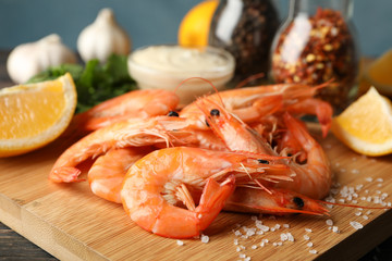 Composition with delicious shrimps on wooden background, close up