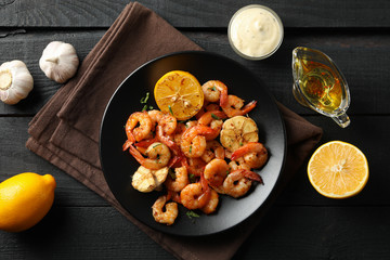 Composition with delicious shrimps on wooden background, top view