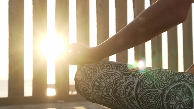 Close up female hand in gyan mudra in sunshine