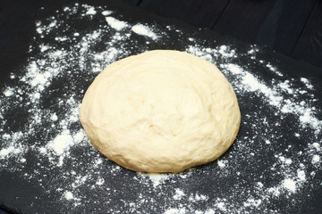 Raw dough on a black background.