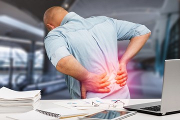 Business man with back pain in office