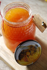 Natural Honey in Jar with Tag with Spanish words "Miel Milflores" which translates to "Honey Thousand flowers"