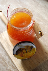 Natural Honey in Jar with Tag with Spanish words "Miel Milflores" which translates to "Honey Thousand flowers"