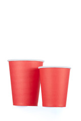 Two biodegradable red paper cups for drinks of different sizes, isolated on a white background.