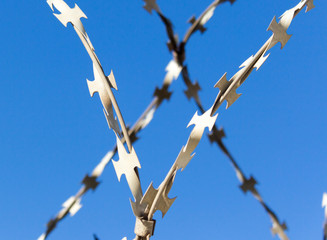 barbed wire against the blue sky