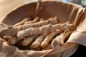 Crispy rye sticks sprinkled with flour. Rustic, laid out on a platter covered with a cloth.