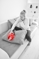 Injured woman holding ice pack / bag for cooling down the knee pain.