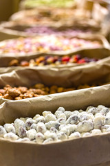 Nuts and oriental sweets in paper bags on the counter