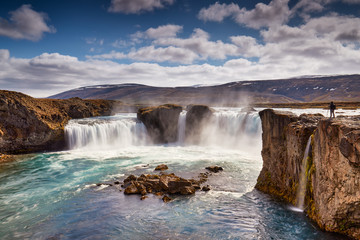 Fototapeta na wymiar Panorama of most famous place of Golden Ring Of Iceland. Godafoss waterfall near Akureyri in the Icelandic highlands, Europe. Popular tourist attraction. Travelling concept background. Postcard.