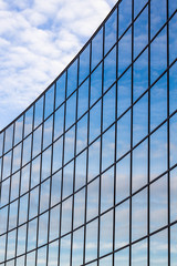Fototapeta na wymiar reflection of sky in windows of modern building
