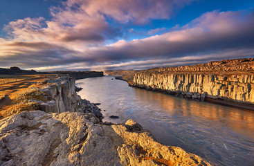 Colorful clouds over Selfoss waterfall. Iceland, Jokulsa National Park, Fjollum river,  Europe. . Popular tourist attraction. Travelling concept background. Golden Ring Of Iceland. Beautiful Postcard.