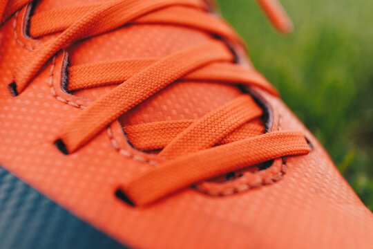 Close-up image of sports cleats. Red sports cleats u designed for field sports such as soccer, football, and baseball