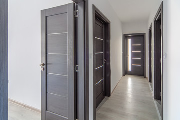 Modern home corridor with doors. Hallway in new apartment. New home. Interior photography.