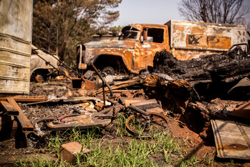 Building and car destroyed by fire during australian bushfires