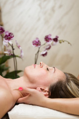 Obraz na płótnie Canvas Closeup face of a woman having neck massage at spa
