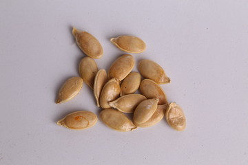 pumpkin seeds on color background