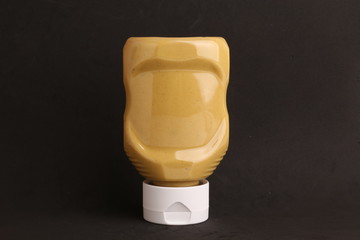 pot of mustard sauce in color background