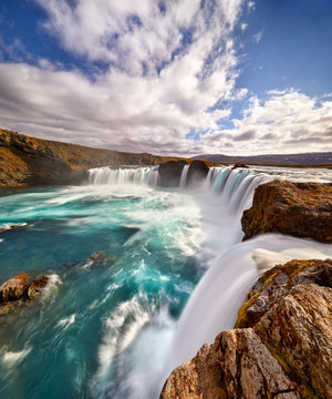 Panorama of most famous place of Golden Ring Of Iceland. Godafoss waterfall near Akureyri in the Icelandic highlands, Europe. Popular tourist attraction. Travelling concept background. Postcard.