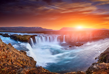 Incredible frosty morning and sunrise at the most famous place of Golden Ring Of Iceland. Godafoss waterfall near Akureyri in the Icelandic highlands, Europe. Popular tourist attraction. Postcard.