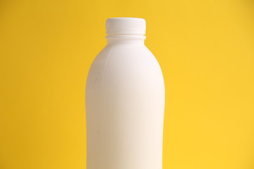 liquid yogurt bottle in color background
